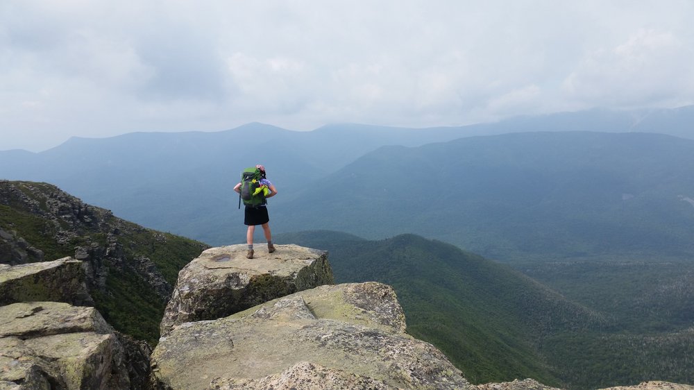 hiking woman looking out onto mountains