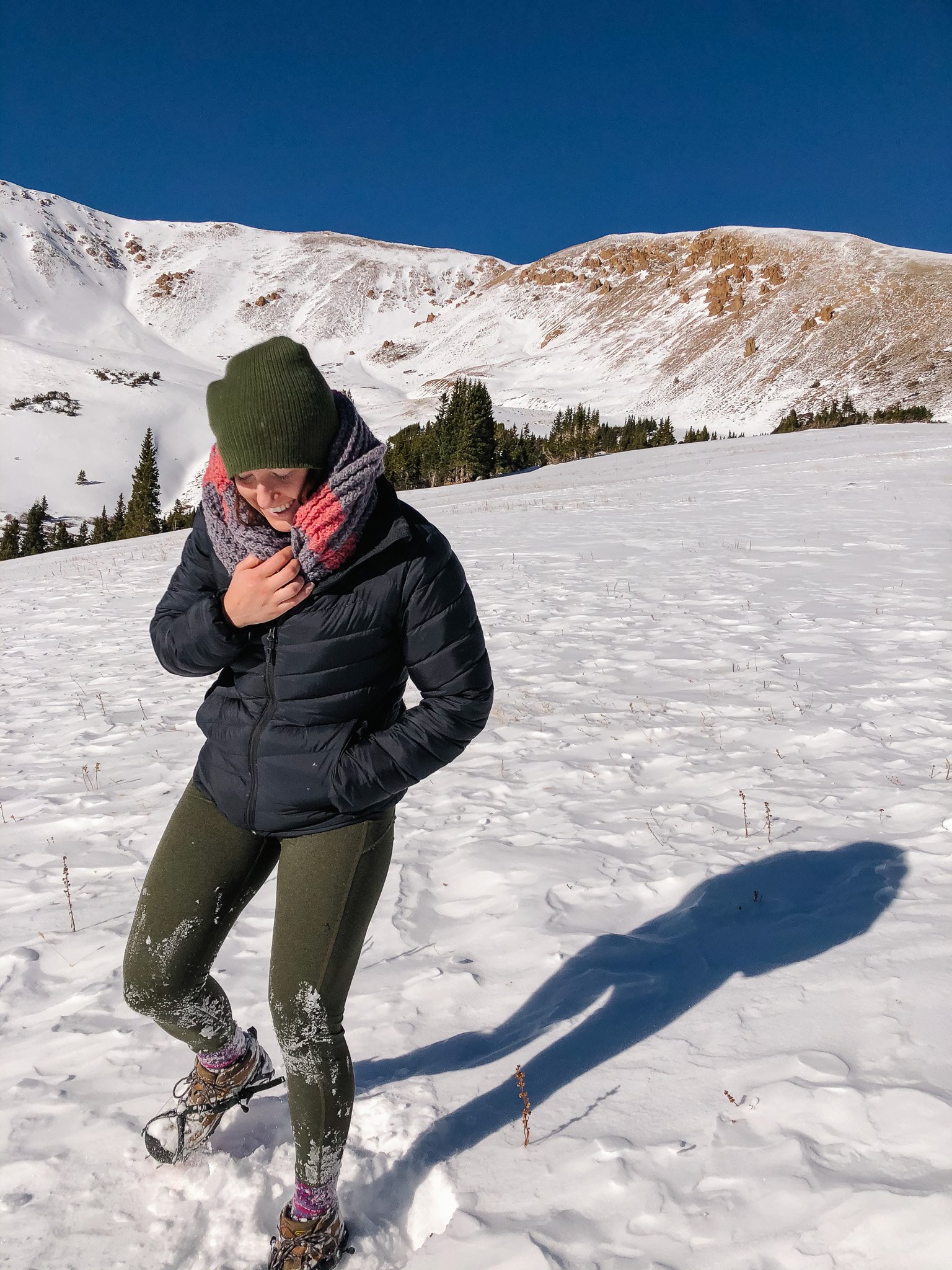 meet the blogger woman standing in snow on a mountain